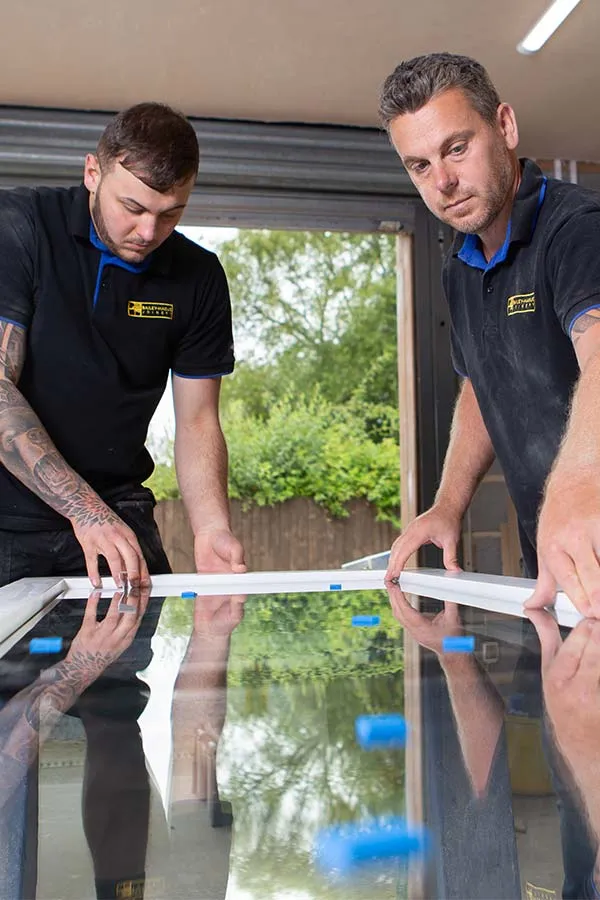 Bailey Hague Joinery craftsman working on bespoke wooden window frame in Yorkshire workshop